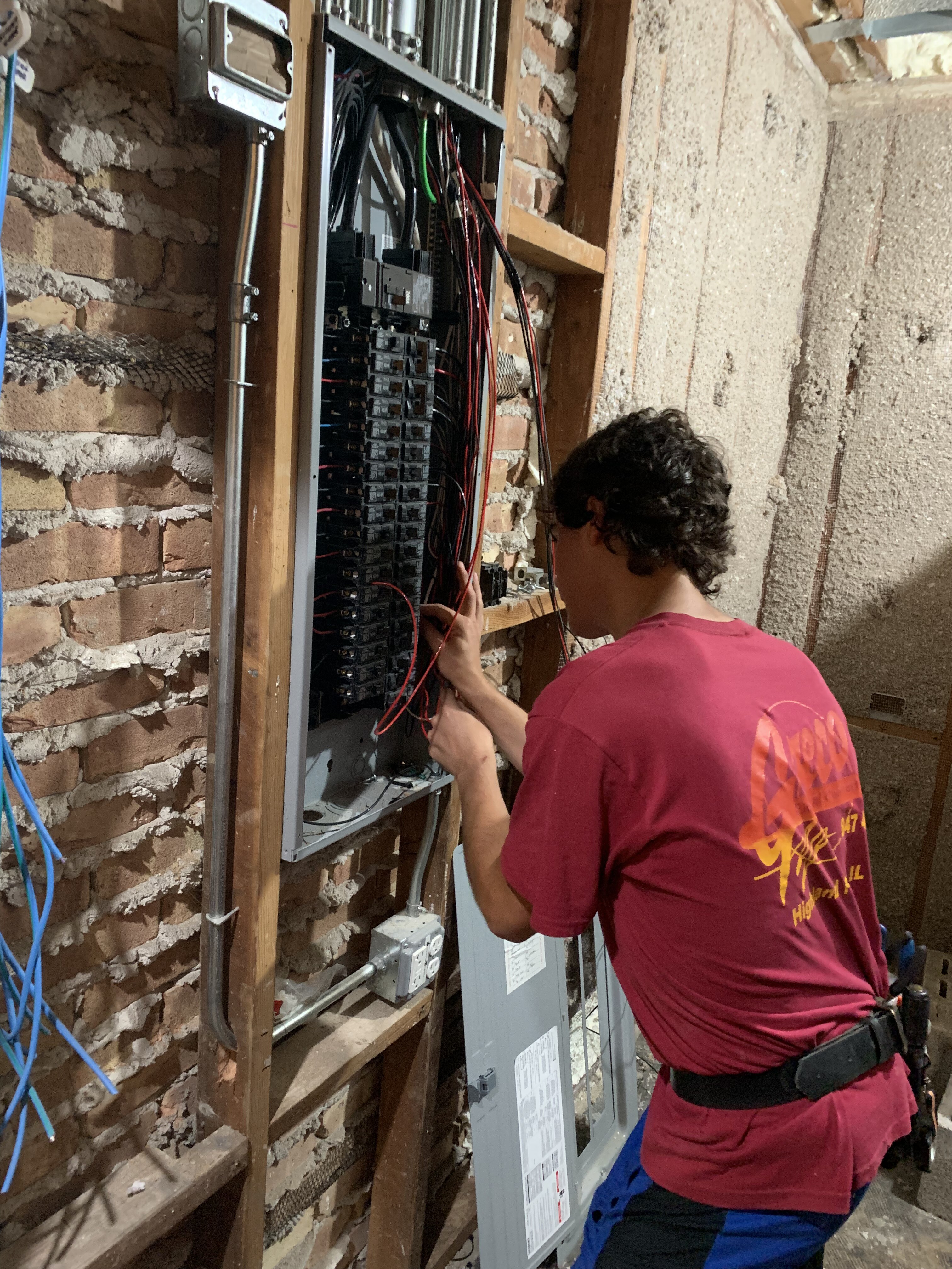 Greco electrician working on a panel in a high-end North Shore home